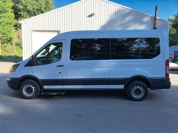 parked white van in front of white shed