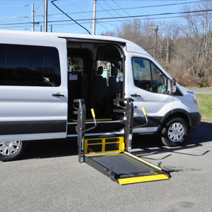 parked white van with lowered platform