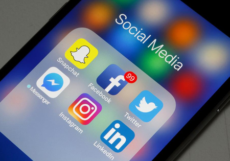 smart phone with snapchat, facebook, twitter, messenger, instagram, and linkedin app